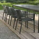 NARDI Net Chairs in Charcoal on wooden deck in outdoor dining setting with Rio Table