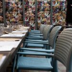 NARDI Bora Arm Chairs in Taupe lined up in restaurant