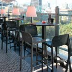 NARDI Lido Tall Outdoor Bar Stools in Charcoal and Taupe at inner city covered outdoor balcony restaurant