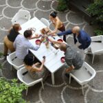 Net Rio 9-Piece Dining Setting in White with people having drinks