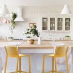 NARDI Trill Tall Bar Stools in Mustard Yellow at bench in white kitchen with natural wood accents