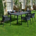 The Net Levante 7 Piece Dining Set in Charcoal Pictured Outside a Country Home Garden