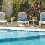 Omega Spritz 5 Piece Sun Lounger Set 2 Omega Sun Loungers (White & Taupe) with Spritz Tables (White) next to Pool